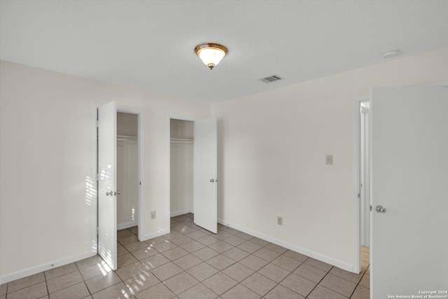 unfurnished bedroom featuring light tile patterned floors