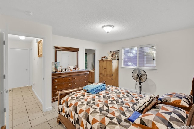 tiled bedroom with a textured ceiling