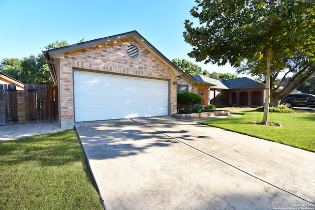 ranch-style home with a garage and a front yard