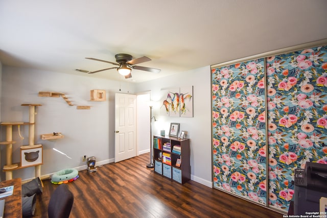 miscellaneous room with ceiling fan and dark hardwood / wood-style flooring