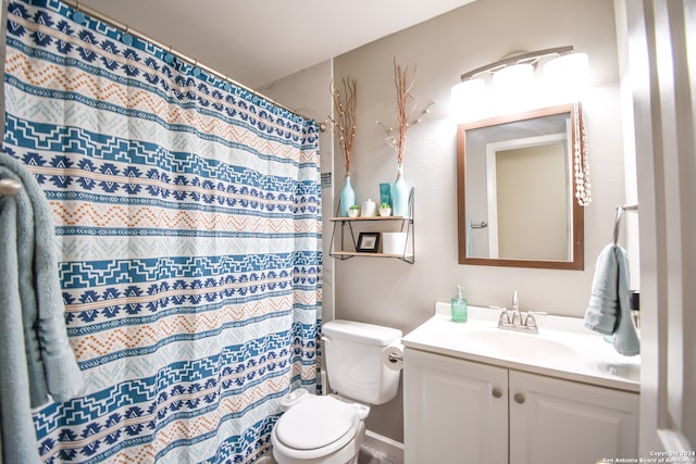 bathroom with vanity, toilet, and curtained shower