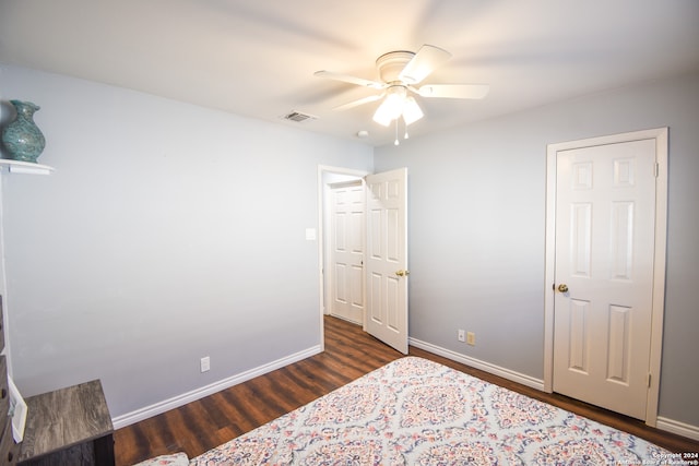 bedroom with ceiling fan and dark hardwood / wood-style flooring