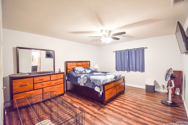 bedroom with ceiling fan and dark hardwood / wood-style floors