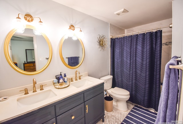 bathroom featuring walk in shower, vanity, toilet, and tile patterned floors