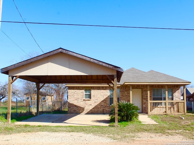 view of front of property featuring a carport and a porch