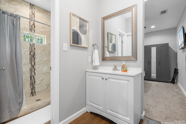 bathroom featuring vanity, hardwood / wood-style floors, and curtained shower