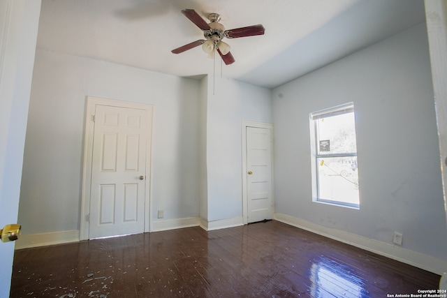 unfurnished room featuring ceiling fan and dark wood-type flooring