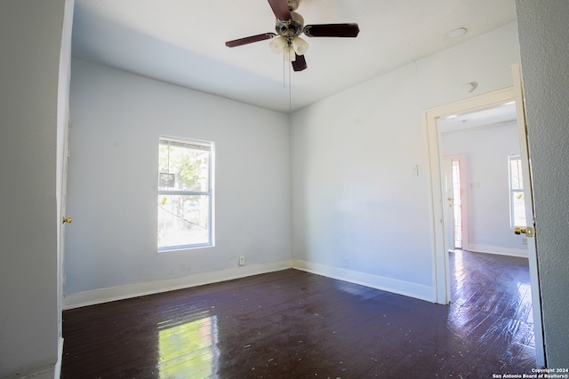 spare room with ceiling fan and dark wood-type flooring