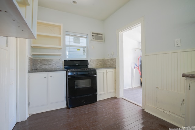 kitchen featuring white cabinetry, tasteful backsplash, dark hardwood / wood-style flooring, a wall unit AC, and gas stove