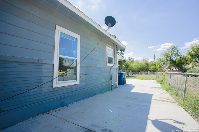 view of property exterior with a patio area