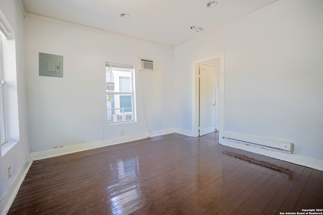 spare room with electric panel, crown molding, and dark hardwood / wood-style flooring