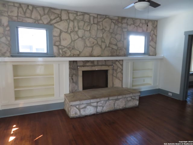 unfurnished living room featuring dark hardwood / wood-style flooring and ceiling fan