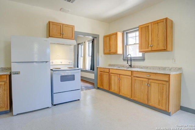 kitchen featuring white appliances and sink