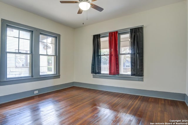 spare room with ceiling fan and dark wood-type flooring