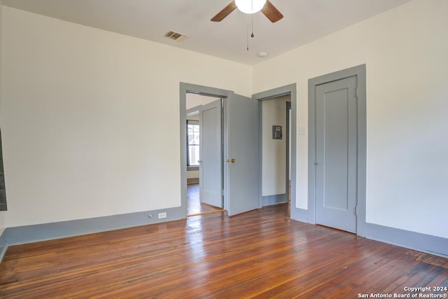 spare room with ceiling fan and dark hardwood / wood-style floors