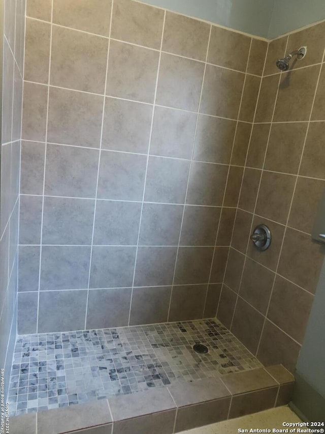 bathroom with a tile shower