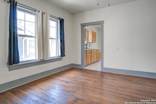 unfurnished room featuring light wood-type flooring and sink