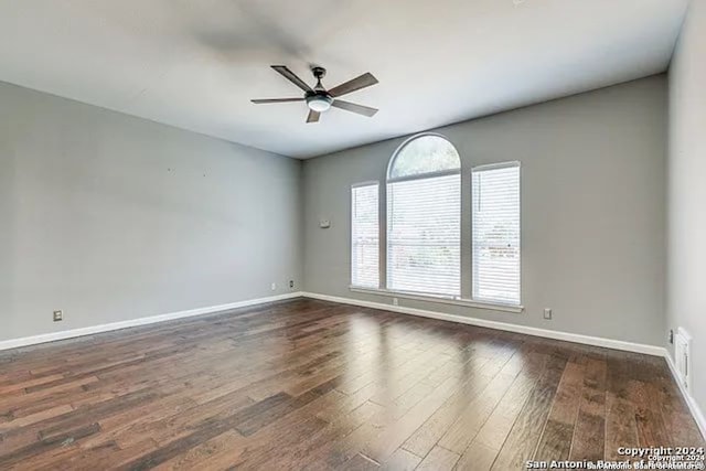 spare room featuring ceiling fan and dark hardwood / wood-style flooring