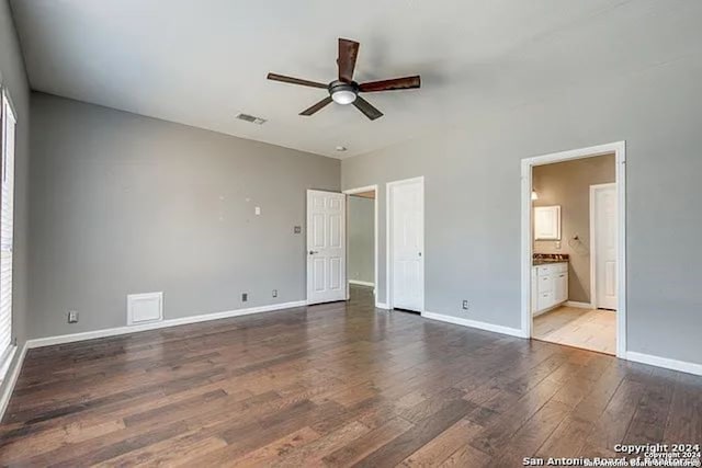 unfurnished bedroom with light wood-type flooring, ensuite bath, and ceiling fan