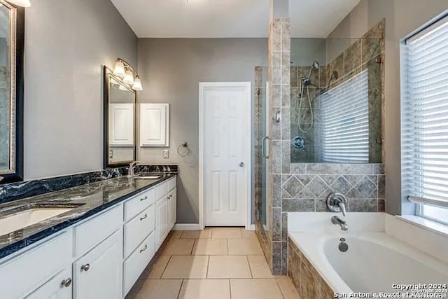 bathroom with independent shower and bath, vanity, and tile patterned floors