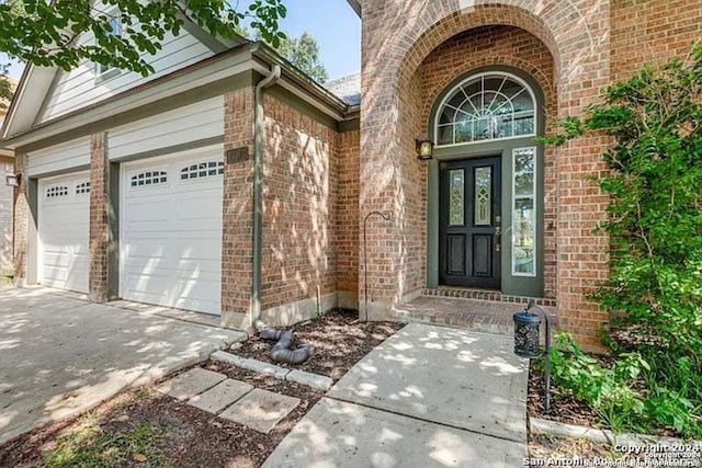 doorway to property with a garage