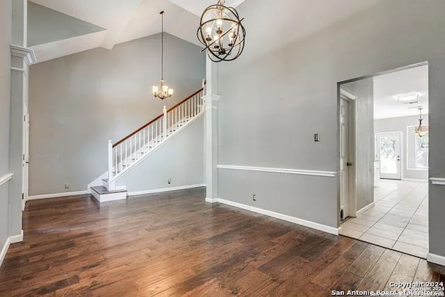 unfurnished living room featuring hardwood / wood-style floors and high vaulted ceiling