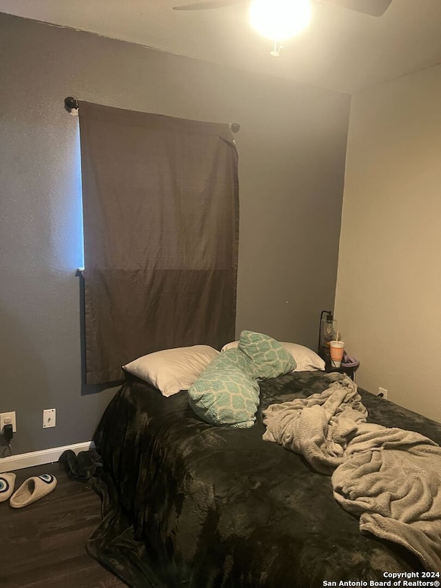 bedroom featuring hardwood / wood-style flooring and ceiling fan