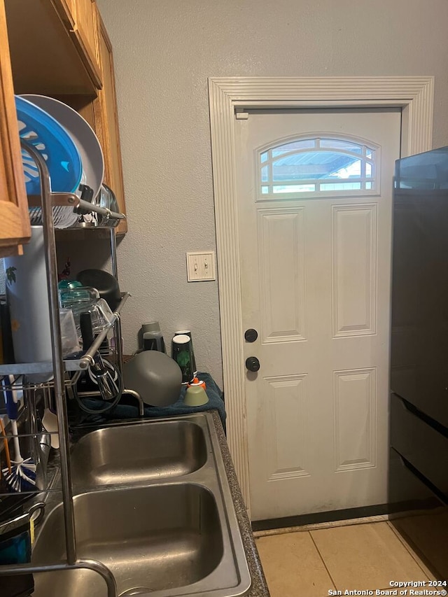 kitchen featuring sink and light tile patterned flooring