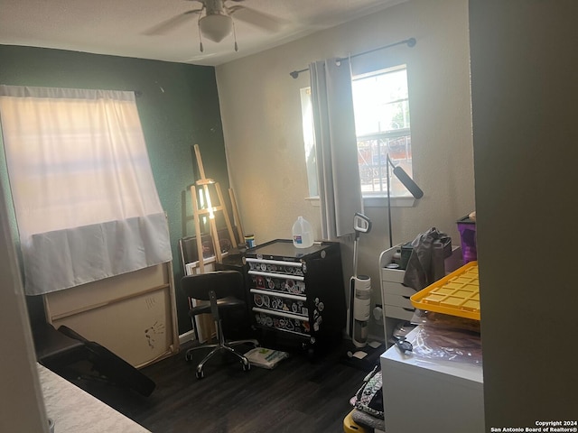 office with ceiling fan and dark wood-type flooring