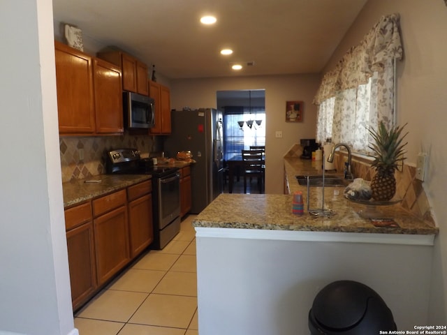 kitchen featuring light tile patterned floors, sink, stainless steel appliances, light stone countertops, and decorative backsplash