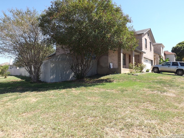 view of side of home with a lawn and a garage