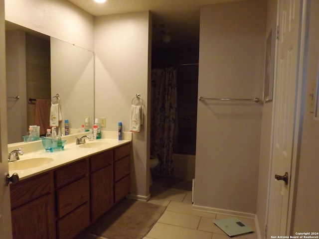 bathroom with a textured ceiling, vanity, a shower with shower curtain, and tile patterned floors