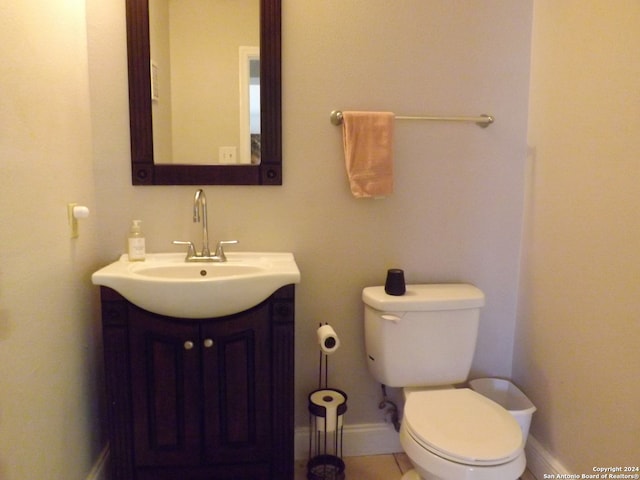 bathroom featuring tile patterned floors, vanity, and toilet