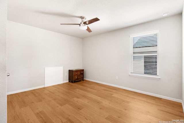 empty room featuring ceiling fan and light wood-type flooring