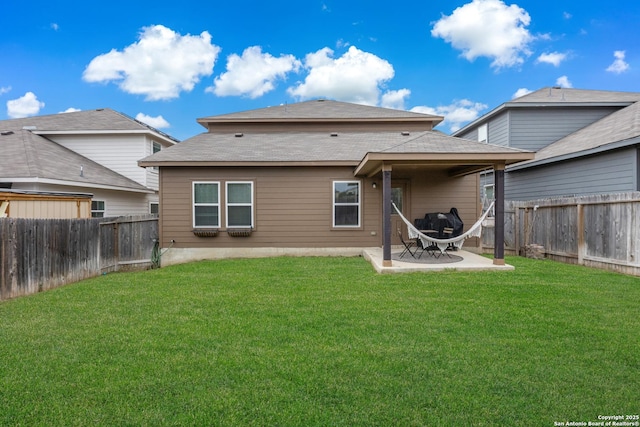 back of house with a yard and a patio