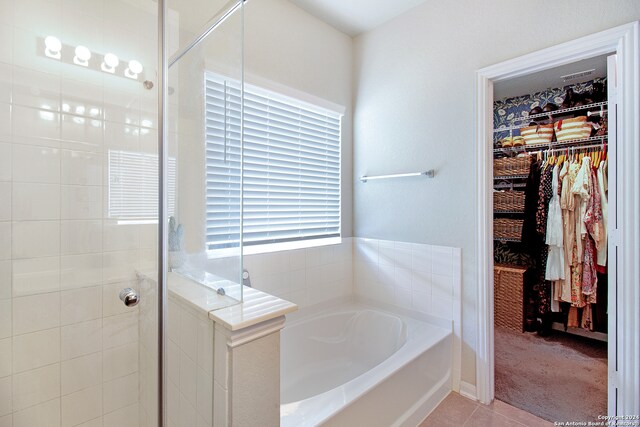 bathroom featuring plus walk in shower and tile patterned floors