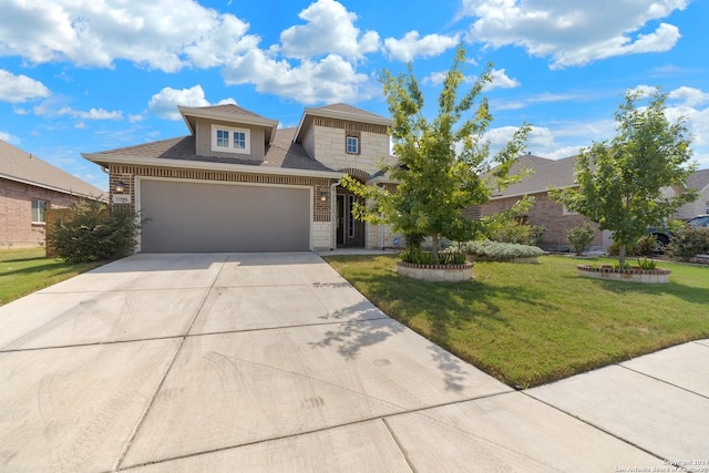 view of front of property with a front yard and a garage