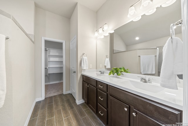 bathroom featuring vanity and vaulted ceiling