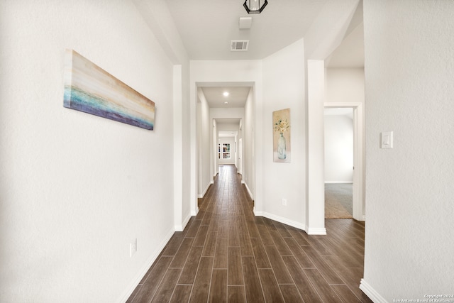 hallway with dark hardwood / wood-style flooring