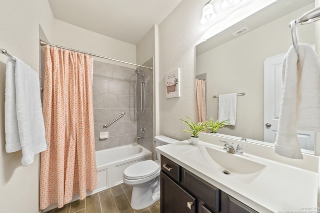 full bathroom with vanity, shower / bath combination with curtain, and toilet