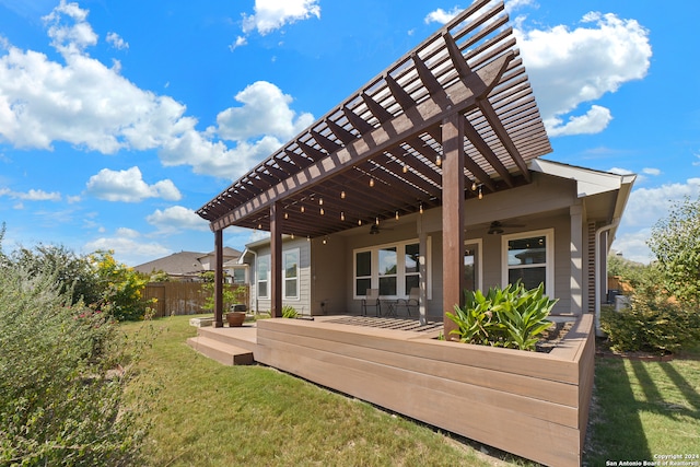 rear view of house featuring a yard, ceiling fan, and a pergola