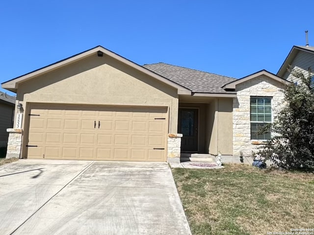 single story home featuring a garage and a front yard