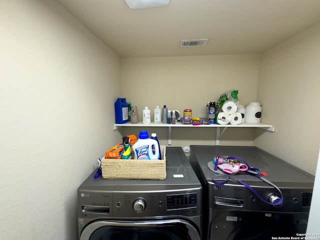 clothes washing area featuring washer and clothes dryer