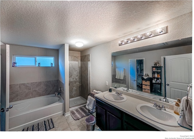 bathroom featuring shower with separate bathtub, a textured ceiling, and vanity