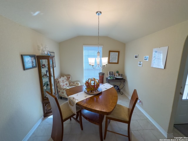 dining area featuring light tile patterned floors, a notable chandelier, and vaulted ceiling