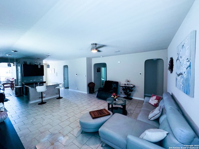 living room with light tile patterned floors and ceiling fan