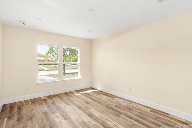 unfurnished room with light hardwood / wood-style floors