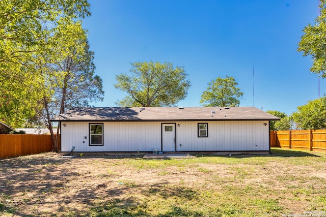 back of property featuring a yard