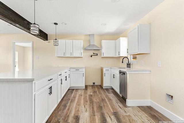 kitchen with white cabinetry, hardwood / wood-style flooring, hanging light fixtures, and wall chimney range hood