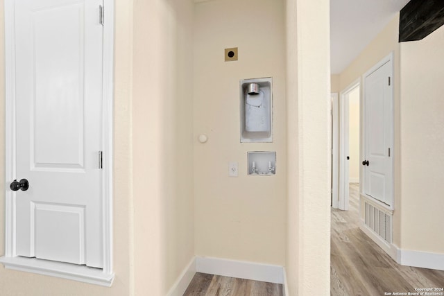 clothes washing area featuring light wood-type flooring, hookup for a washing machine, and electric dryer hookup